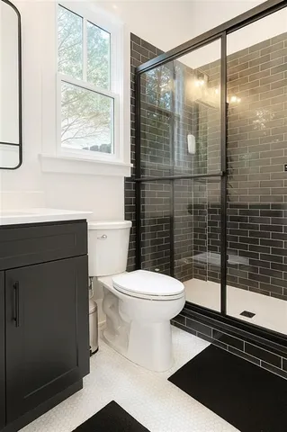 a bathroom with a toilet a sink and shower