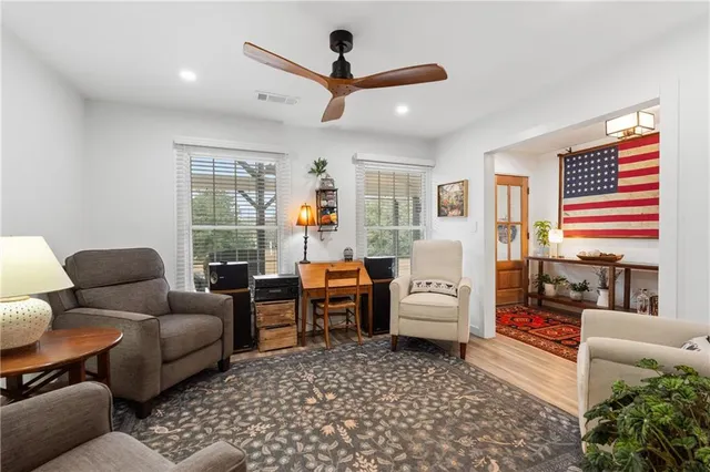 a bedroom with furniture and a wooden floor