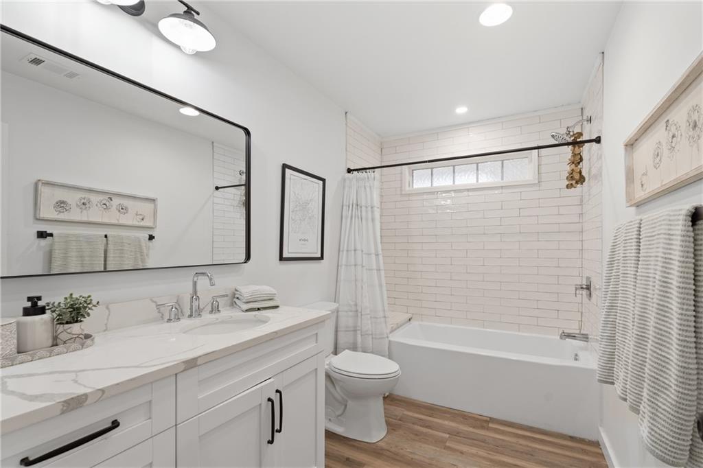 4535 South Barnett Shoals Road Athens, GA 30605 - Photo 20 of 60 a bathroom with a granite countertop sink toilet a mirror and shower