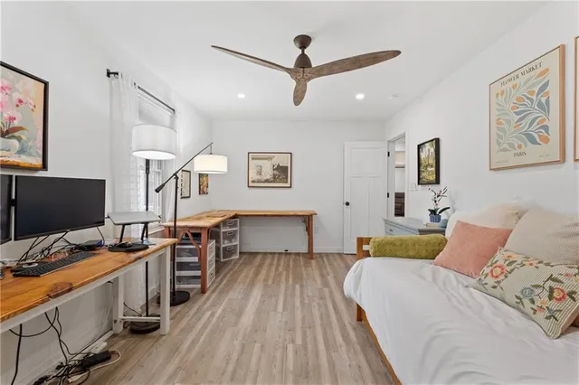 a bedroom with a bed and wooden floor