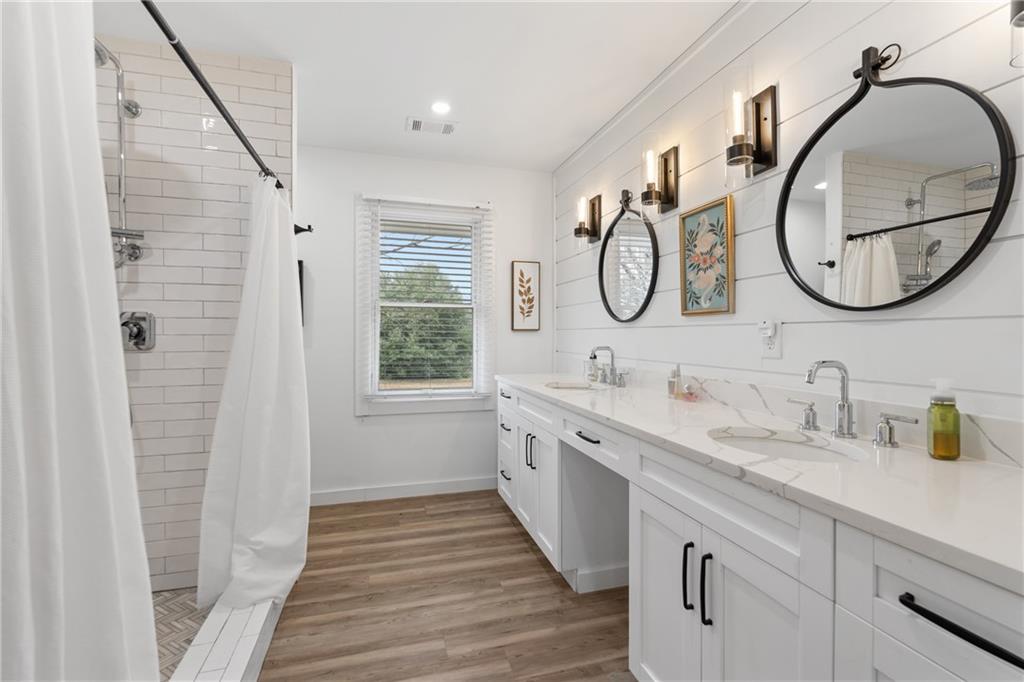 4535 South Barnett Shoals Road Athens, GA 30605 - Photo 27 of 60 a bathroom with a double vanity sink and a mirror
