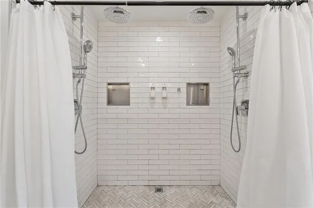 a room with wooden floor and a potted plant
