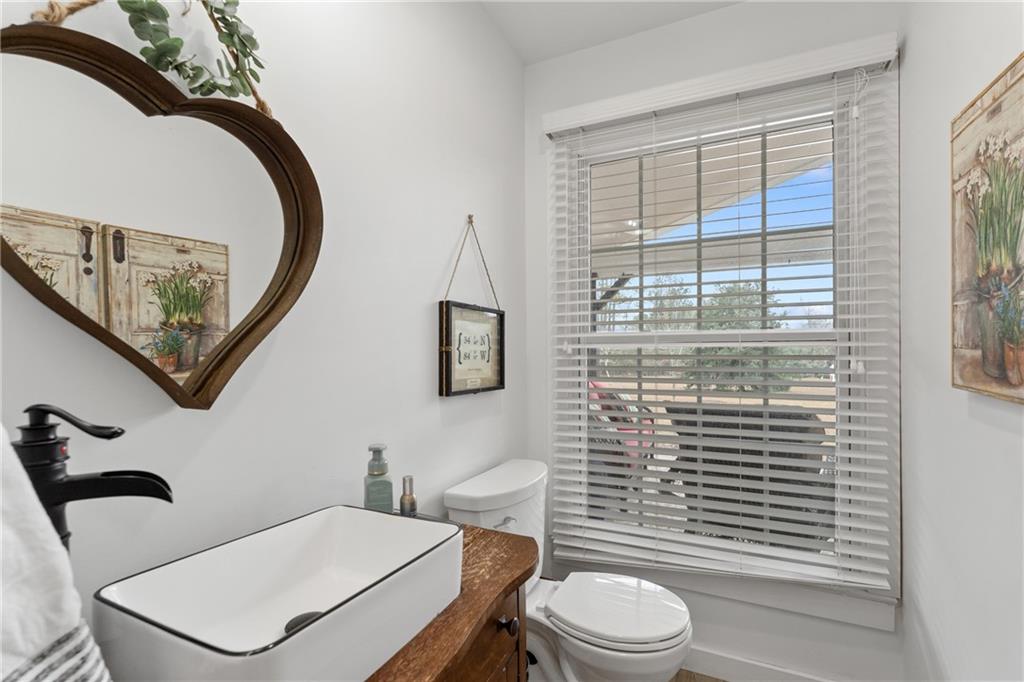 4535 South Barnett Shoals Road Athens, GA 30605 - Photo 30 of 60 a bathroom with a toilet a sink and mirror