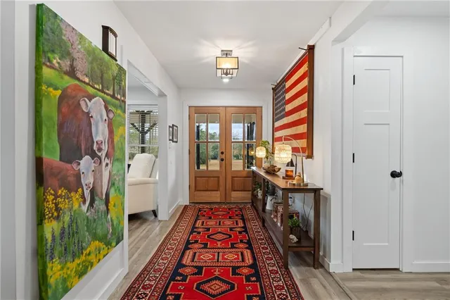a view of a house with floor to ceiling windows and a basket ball poll