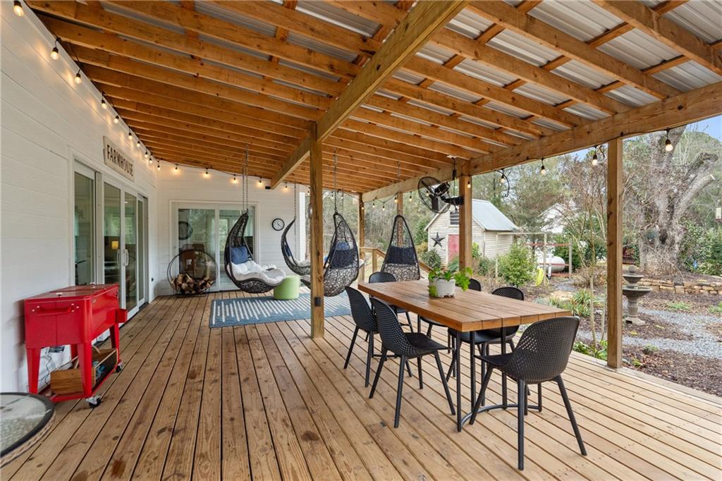 4535 South Barnett Shoals Road Athens, GA 30605 - Photo 34 of 60 a view of a patio with table and chairs and wooden floor