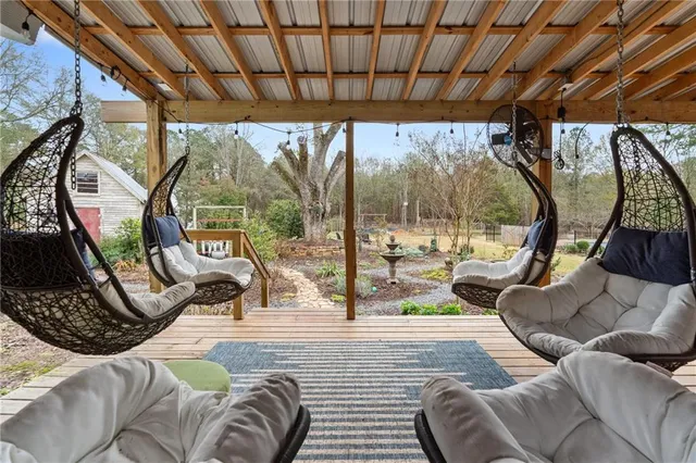 a backyard of a house with table and chairs
