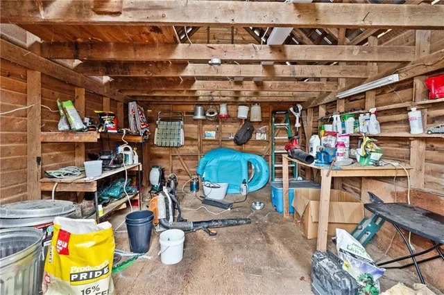 a front view of a house with a yard covered with trees