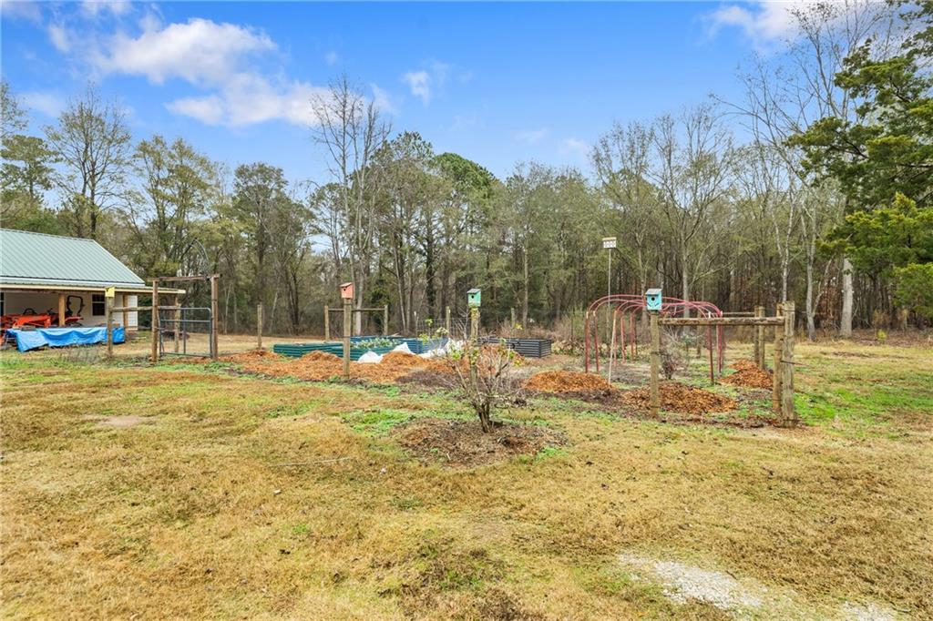 4535 South Barnett Shoals Road Athens, GA 30605 - Photo 50 of 60 a view of a swimming pool with a bench and trees in the background