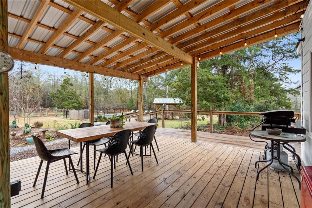 4535 South Barnett Shoals Road Athens, GA 30605 - Photo 56 of 60 a view of a patio with a table and chairs