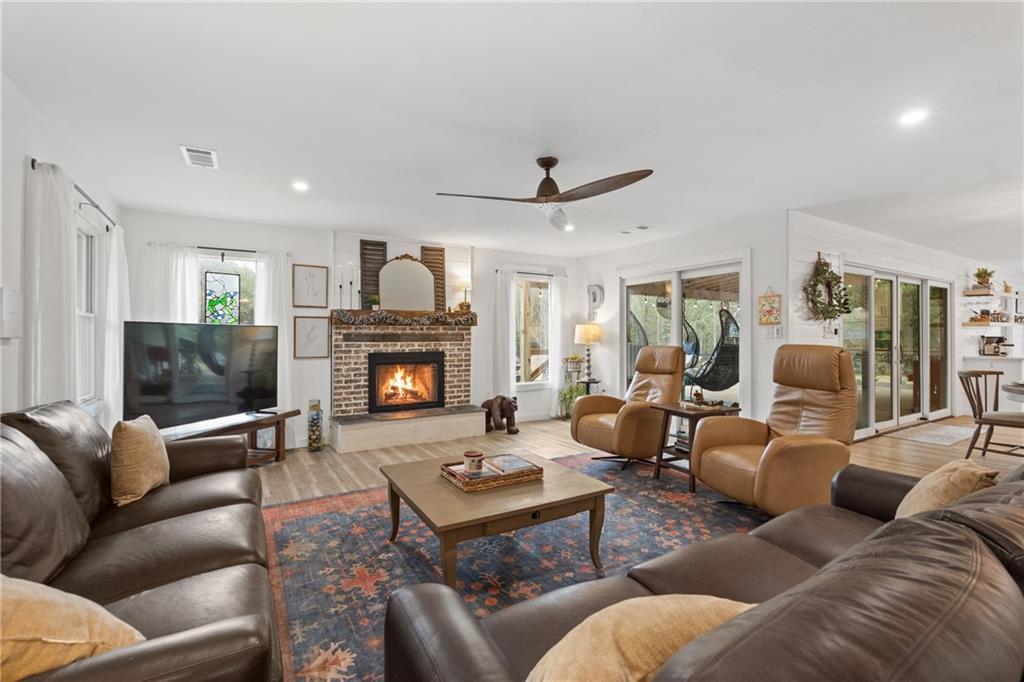 4535 South Barnett Shoals Road Athens, GA 30605 - Photo 8 of 60 a living room with furniture a fireplace and a flat screen tv