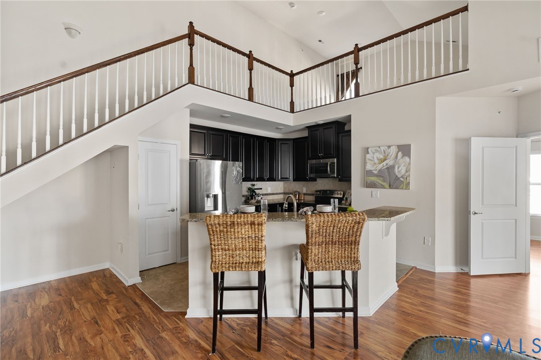 1201 Westwood Village Lane, Unit 402 Midlothian, VA 23114 - Photo 11 of 27 a view of a dining room with furniture window and wooden floor