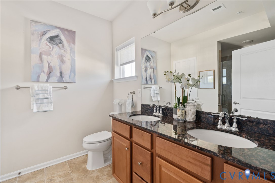 1201 Westwood Village Lane, Unit 402 Midlothian, VA 23114 - Photo 15 of 27 a bathroom with a granite countertop sink mirror vanity and toilet