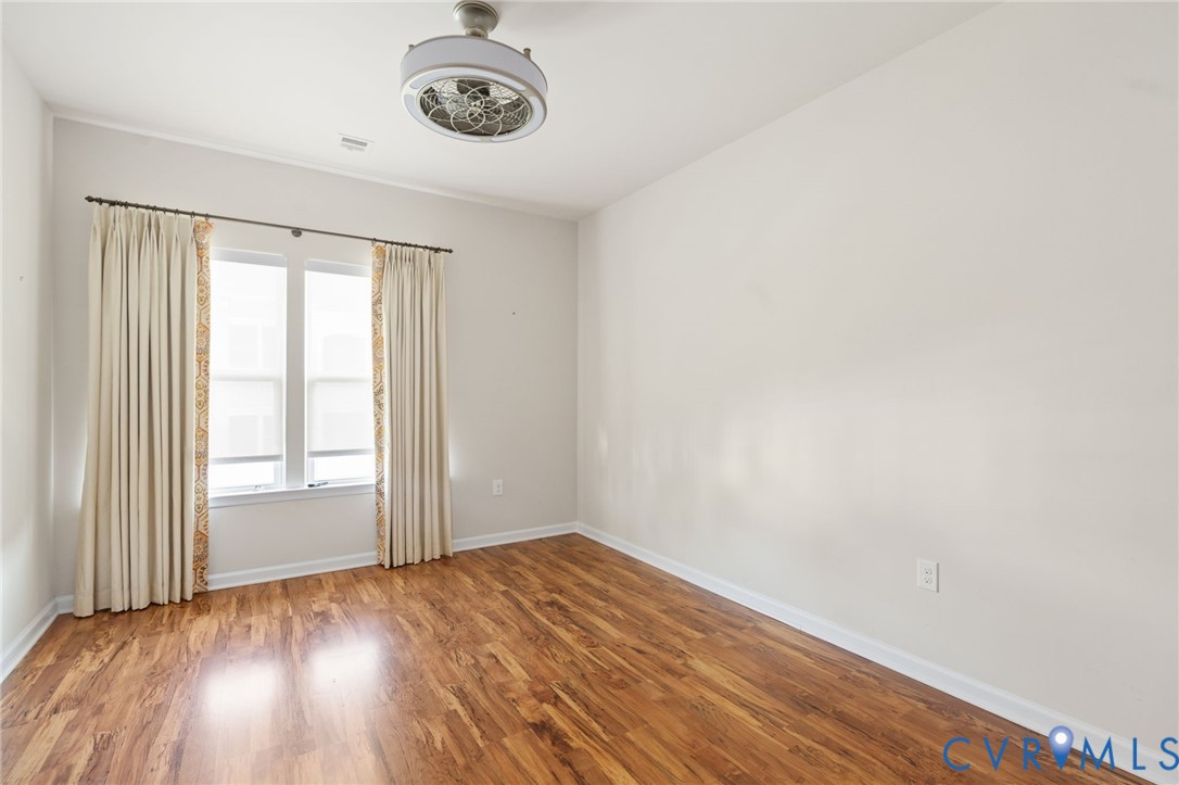 1201 Westwood Village Lane, Unit 402 Midlothian, VA 23114 - Photo 18 of 27 an empty room with a window and wooden floor