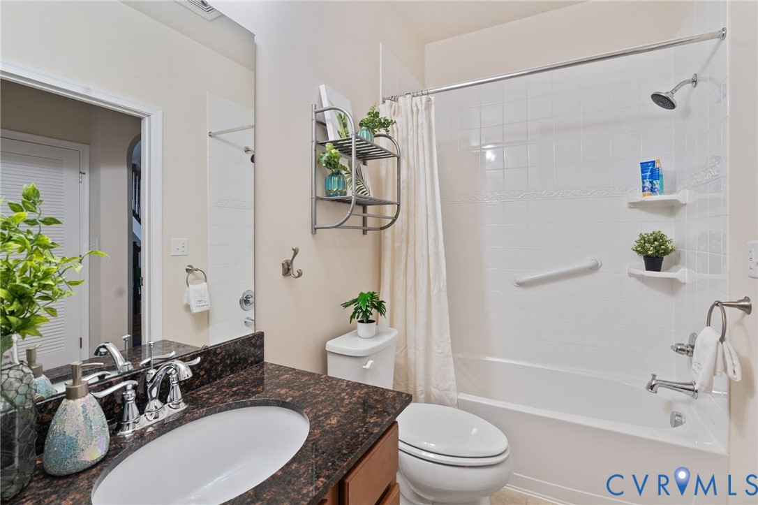 1201 Westwood Village Lane, Unit 402 Midlothian, VA 23114 - Photo 20 of 27 a bathroom with a granite countertop sink a toilet and shower