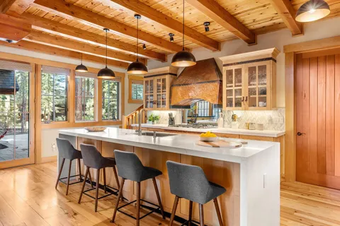 a dining table with chairs and wooden floor