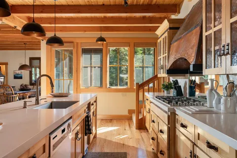 a kitchen with stainless steel appliances granite countertop a sink and a stove