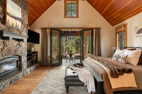 a bed sitting in a bedroom next to a window