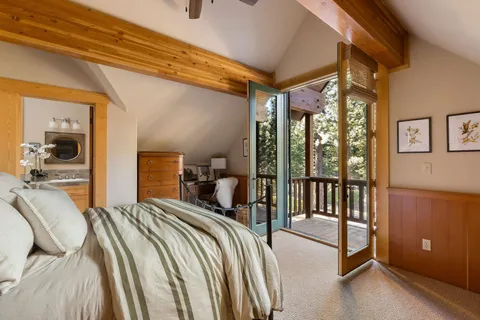 a bedroom with a large bed and a chandelier