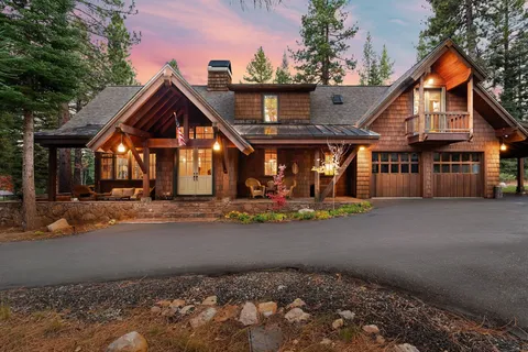 a front view of a house with basket ball court and potted plants
