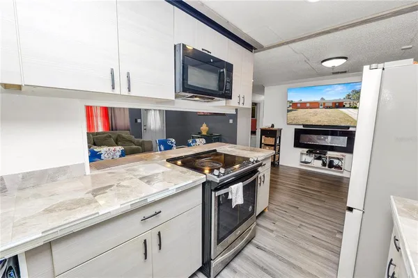 a kitchen with stainless steel appliances granite countertop a stove and a refrigerator