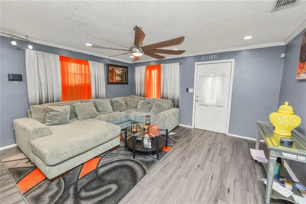 a living room with fireplace furniture and a flat screen tv