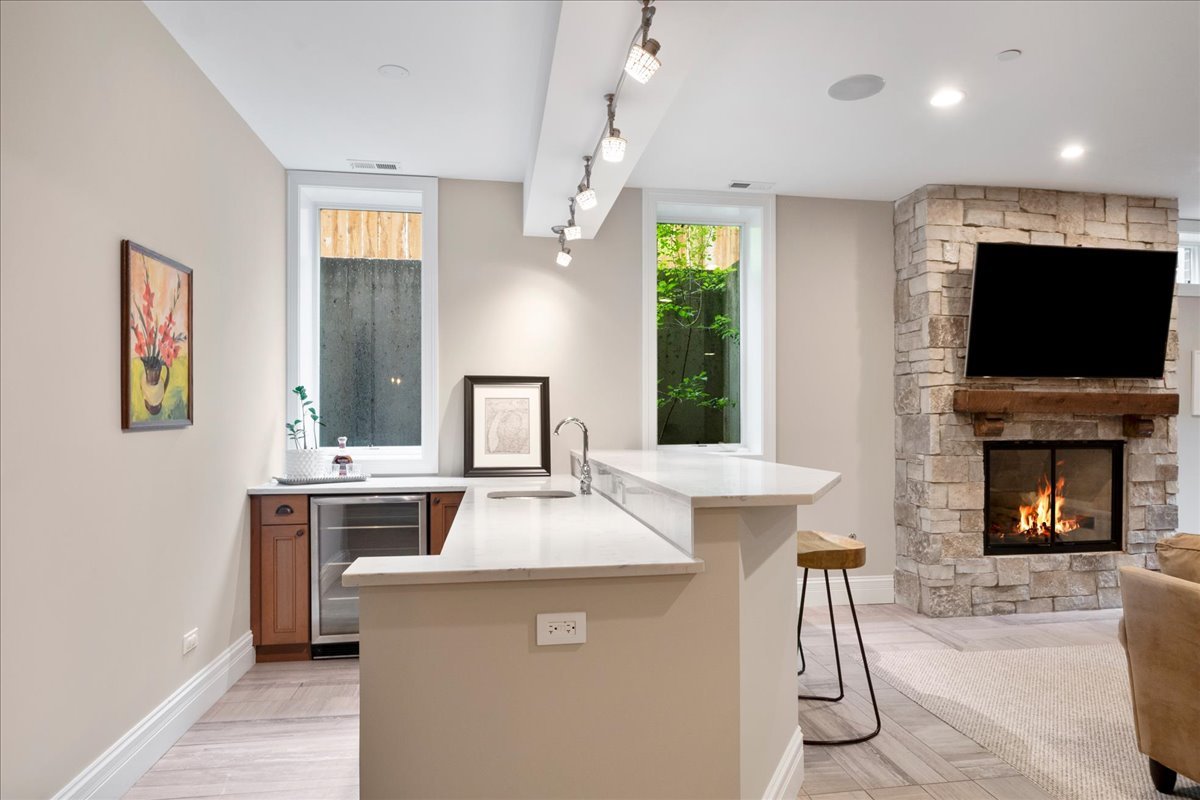2921 Simpson Street Evanston, IL 60201 - Photo 26 of 41 a kitchen with a stove a refrigerator and a fireplace