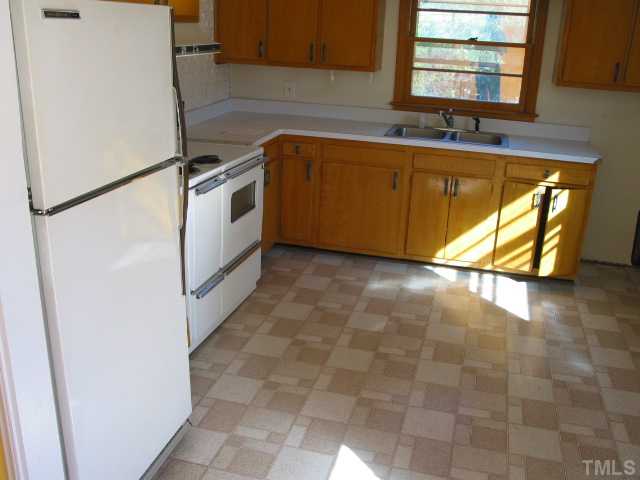 4317 James Road Raleigh, NC 27616 - Photo 3 of 13 a kitchen with granite countertop a sink a stove a washer and dryer