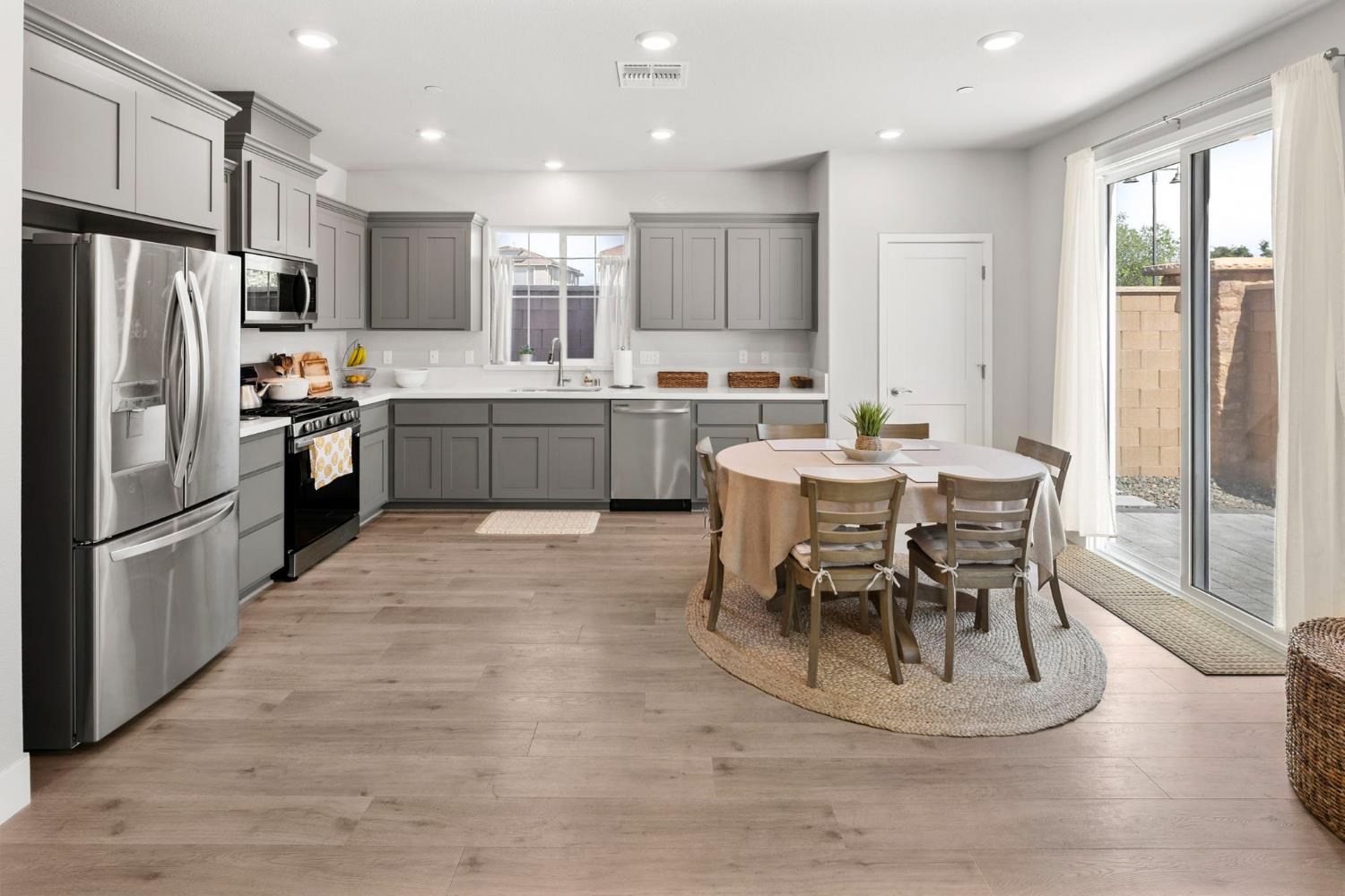 1508 Westwind Way Rocklin, CA 95765 - Photo 11 of 45 a kitchen with a table chairs refrigerator and chairs