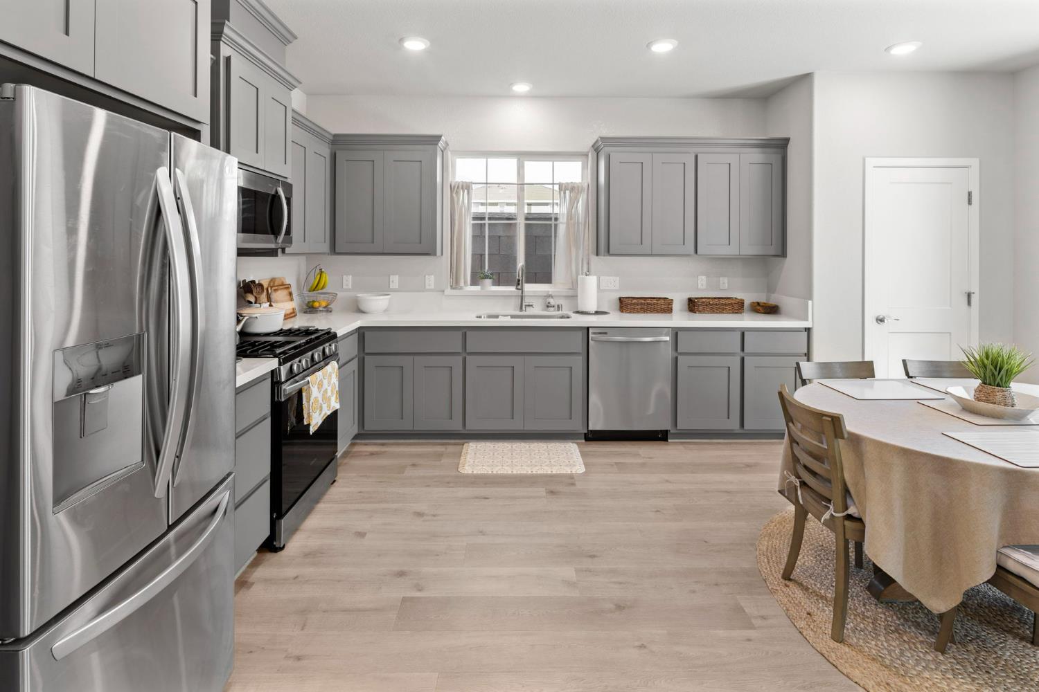 1508 Westwind Way Rocklin, CA 95765 - Photo 12 of 45 a kitchen with stainless steel appliances granite countertop a stove refrigerator sink and microwave