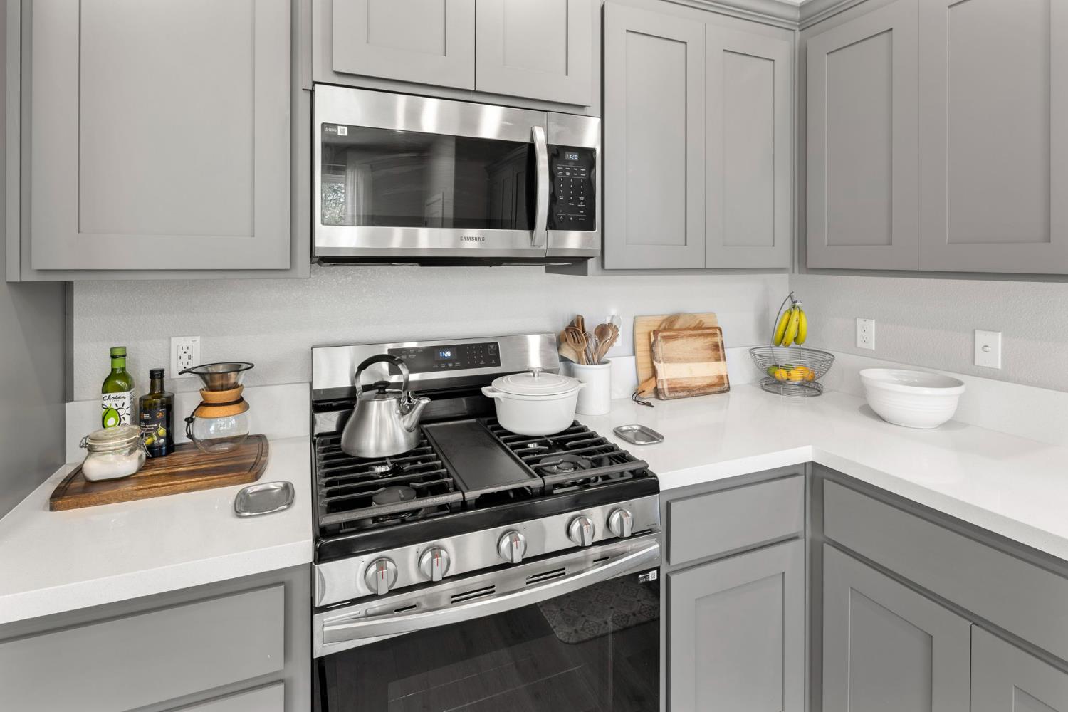 1508 Westwind Way Rocklin, CA 95765 - Photo 13 of 45 a kitchen with stainless steel appliances granite countertop white cabinets and a stove top oven
