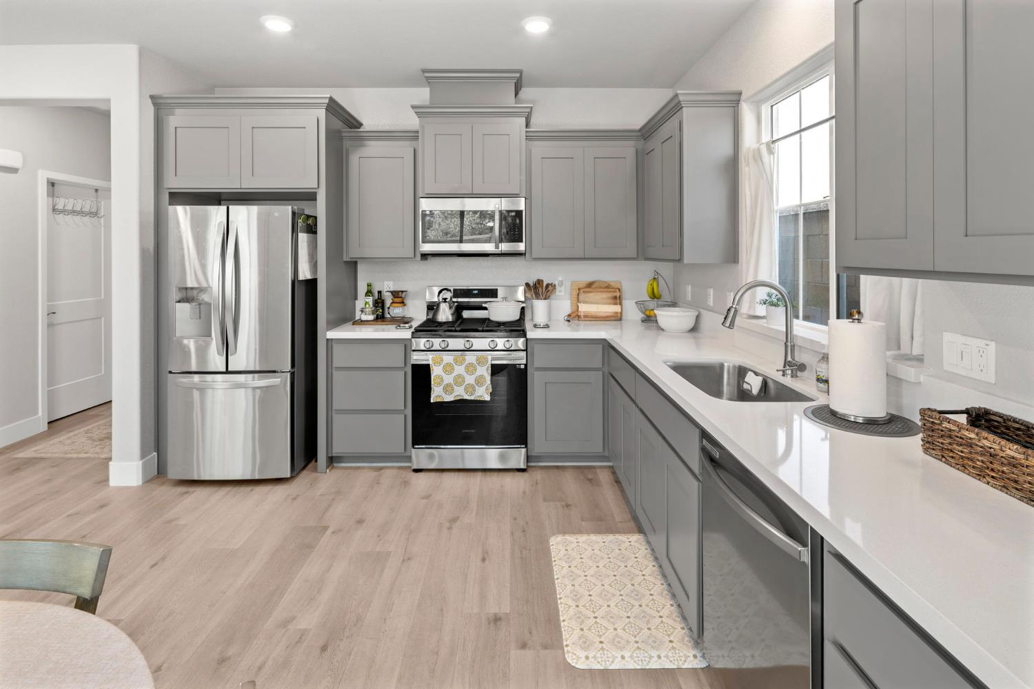 1508 Westwind Way Rocklin, CA 95765 - Photo 14 of 45 a kitchen with stainless steel appliances granite countertop a refrigerator a sink dishwasher a stove top oven a refrigerator and white cabinets