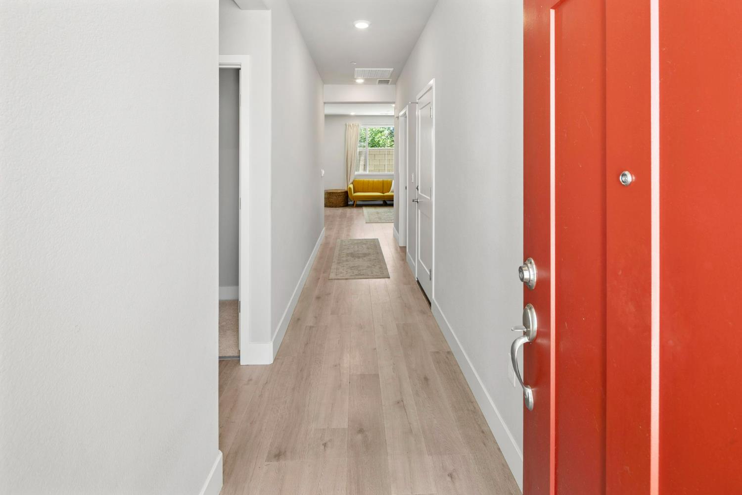 1508 Westwind Way Rocklin, CA 95765 - Photo 6 of 45 a view of a hallway with wooden floor and a bathroom