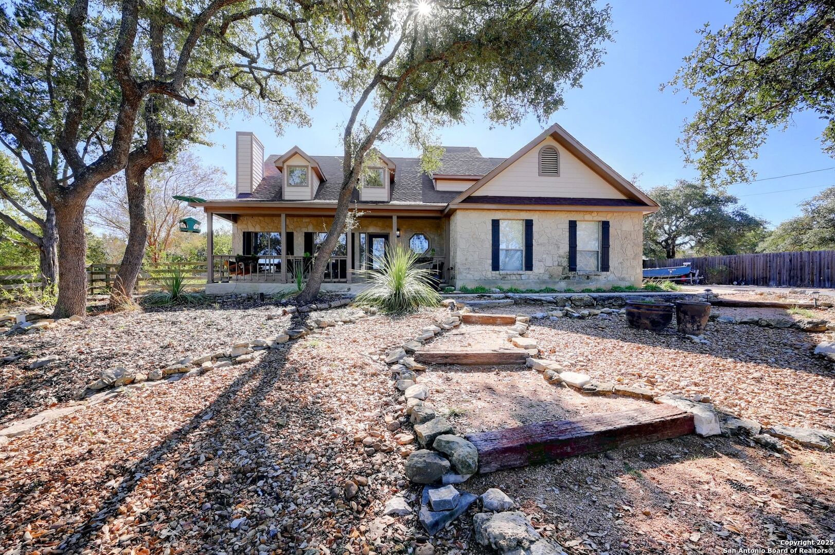 a front view of a house with yard and trees