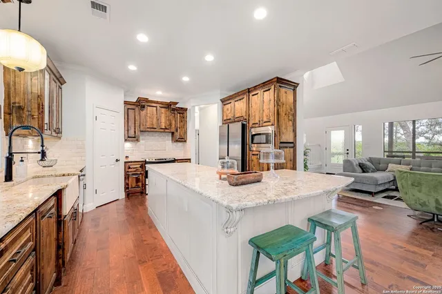 a kitchen with a sink a counter top space and appliances