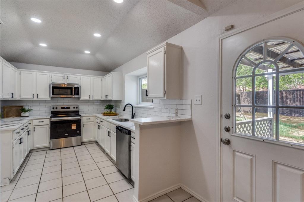 1509 Clover Drive Allen, TX 75002 - Photo 15 of 25 a large kitchen with stainless steel appliances granite countertop a stove a sink dishwasher and a refrigerator