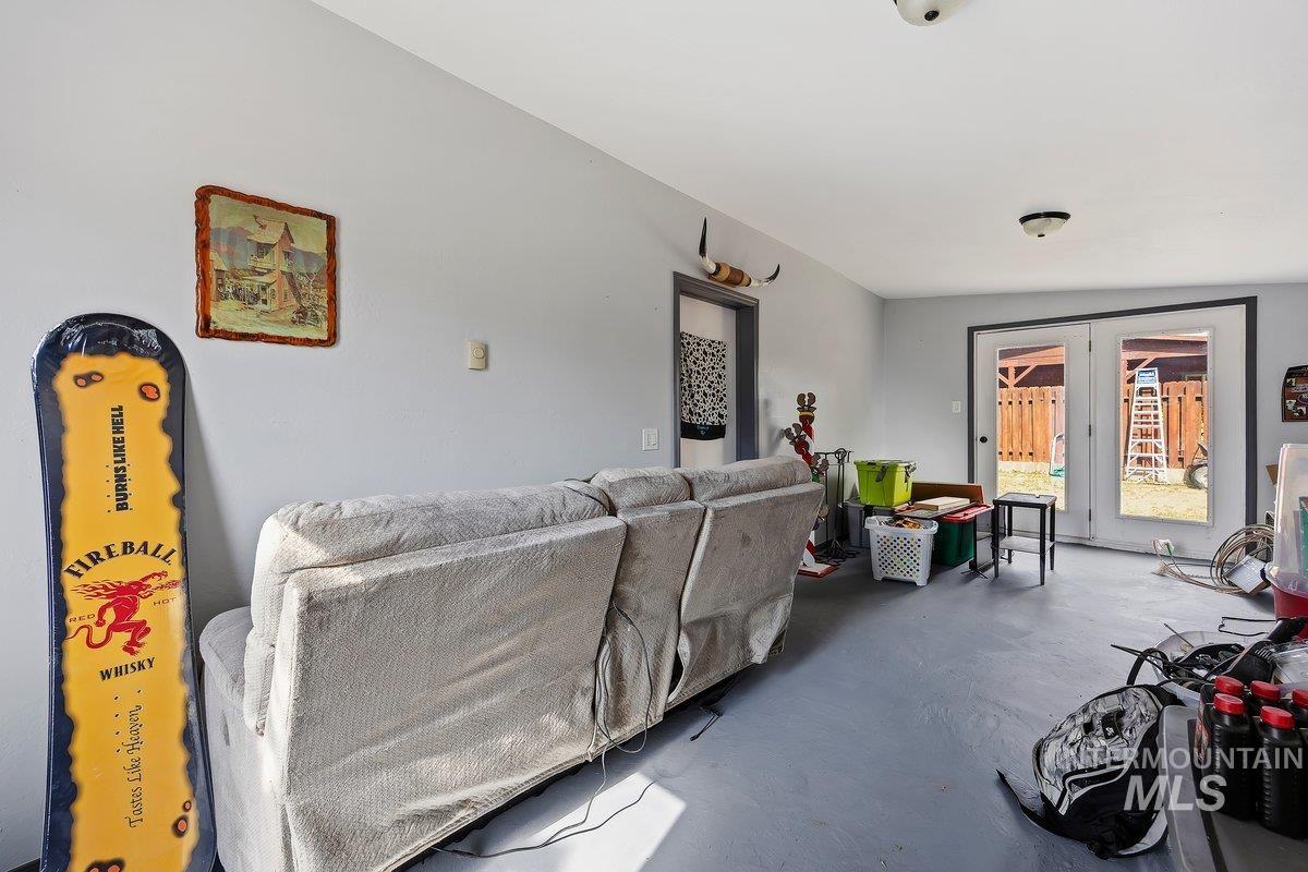 418 South Date Street Shoshone, ID 83352 - Photo 19 of 36 Spacious room with light gray walls and a matching gray floor