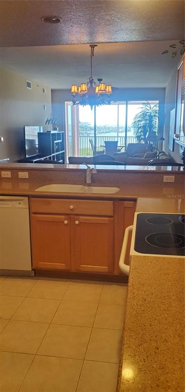 13413 Gasparilla Road, Unit 304 Placida, FL 33946 - Photo 17 of 28 a kitchen with stainless steel appliances kitchen island granite countertop a sink and a counter top space