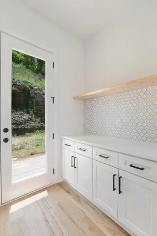 a view of kitchen and kitchen with a sink wooden floor windows