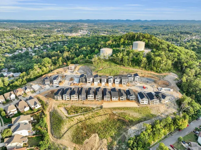 a front view of a large residential apartment building with a yard