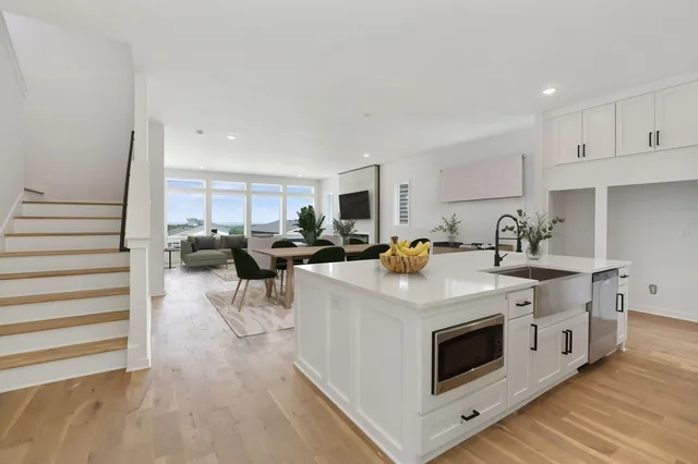 a kitchen with white cabinets and stainless steel appliances