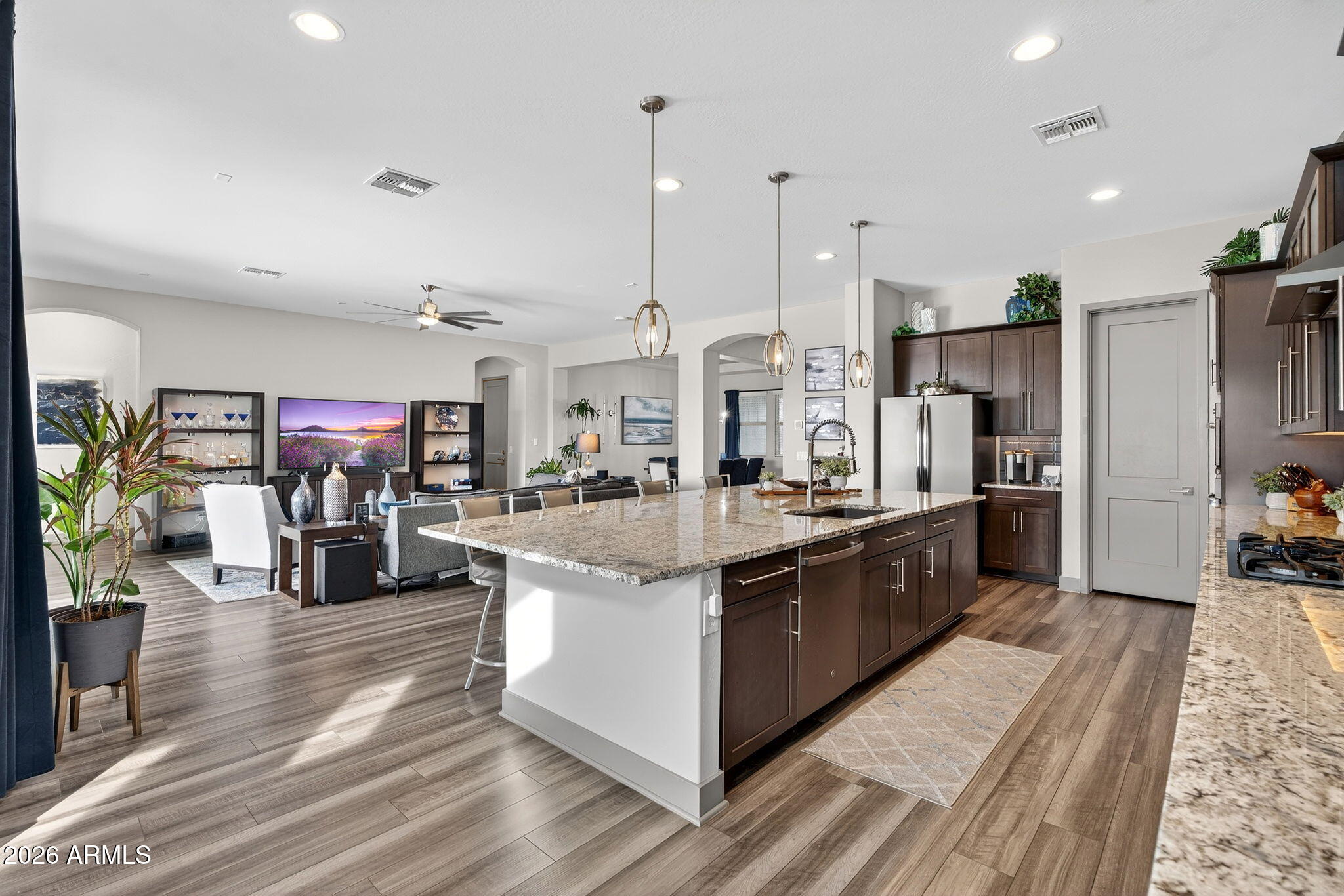 35112 North Jacobs Road San Tan Valley, AZ 85144 - Photo 18 of 80 a large kitchen with stainless steel appliances kitchen island granite countertop a large counter top and stove in it