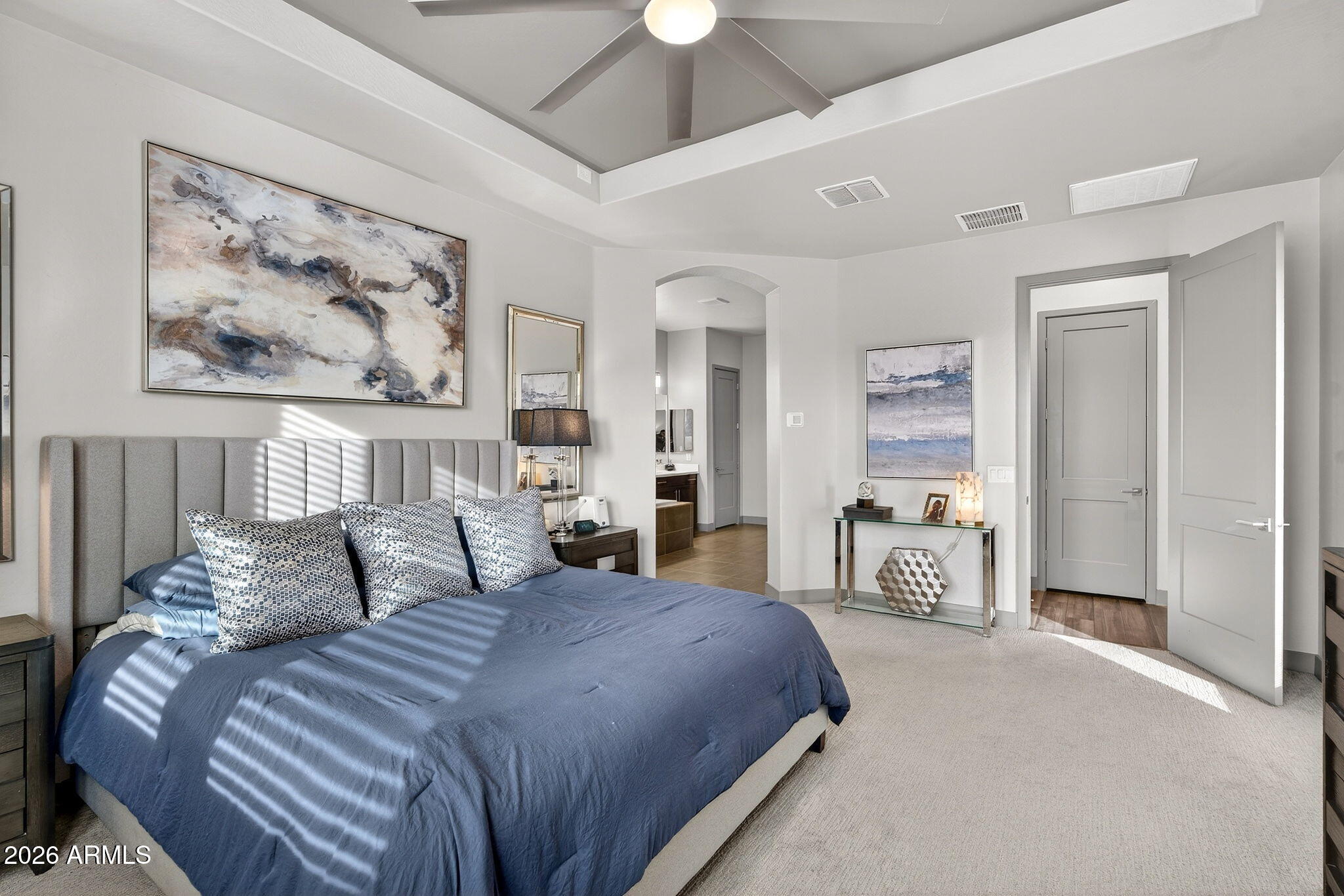 35112 North Jacobs Road San Tan Valley, AZ 85144 - Photo 33 of 80 a bedroom with a large bed a chandelier and a painting on the wall