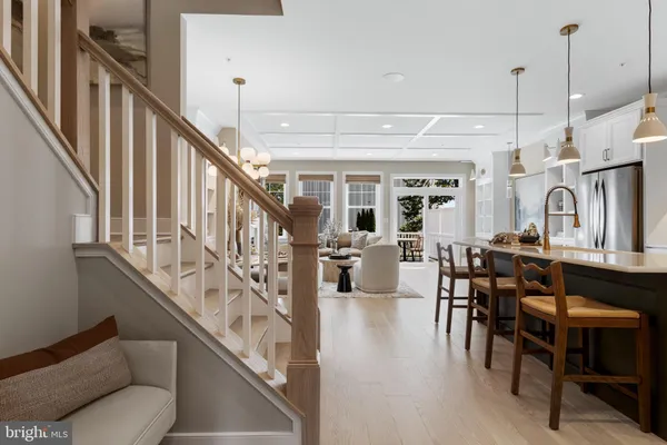a view of a dining room with furniture a rug and wooden floor