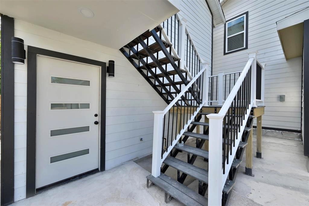 2304 Chapman Street, Unit 3 Houston, TX 77009 - Photo 3 of 17 a view of staircase with white walls and wooden floor