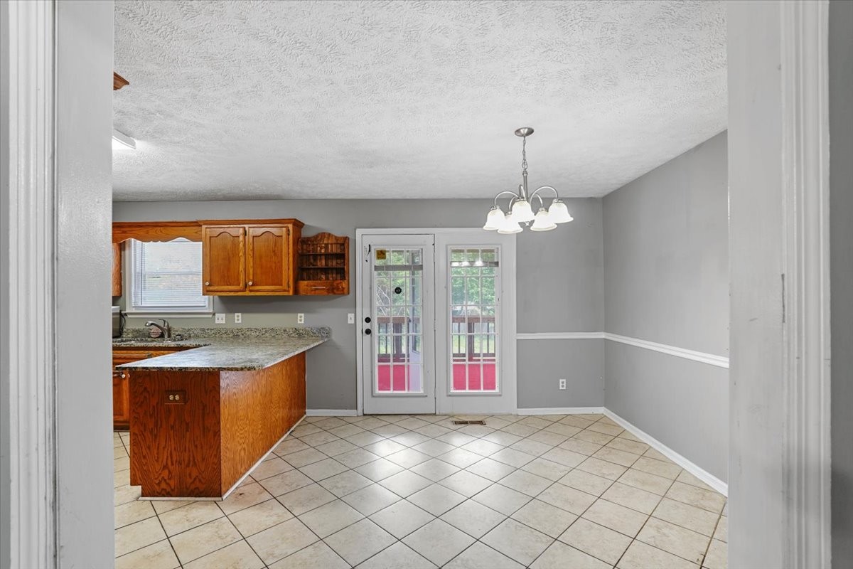 1306 Cason Trail Murfreesboro, TN 37128 - Photo 12 of 38 a view of kitchen with granite countertop stove top oven and chandelier