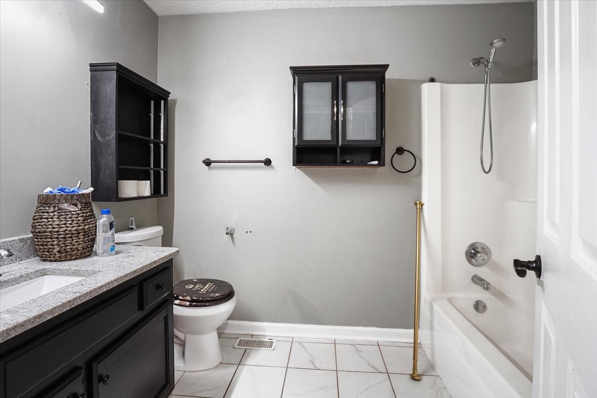 1306 Cason Trail Murfreesboro, TN 37128 - Photo 24 of 38 a bathroom with a granite countertop sink toilet and shower