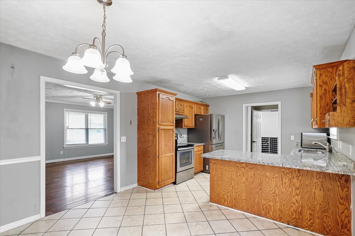 1306 Cason Trail Murfreesboro, TN 37128 - Photo 6 of 38 a view of a kitchen with a sink refrigerator and wooden floor