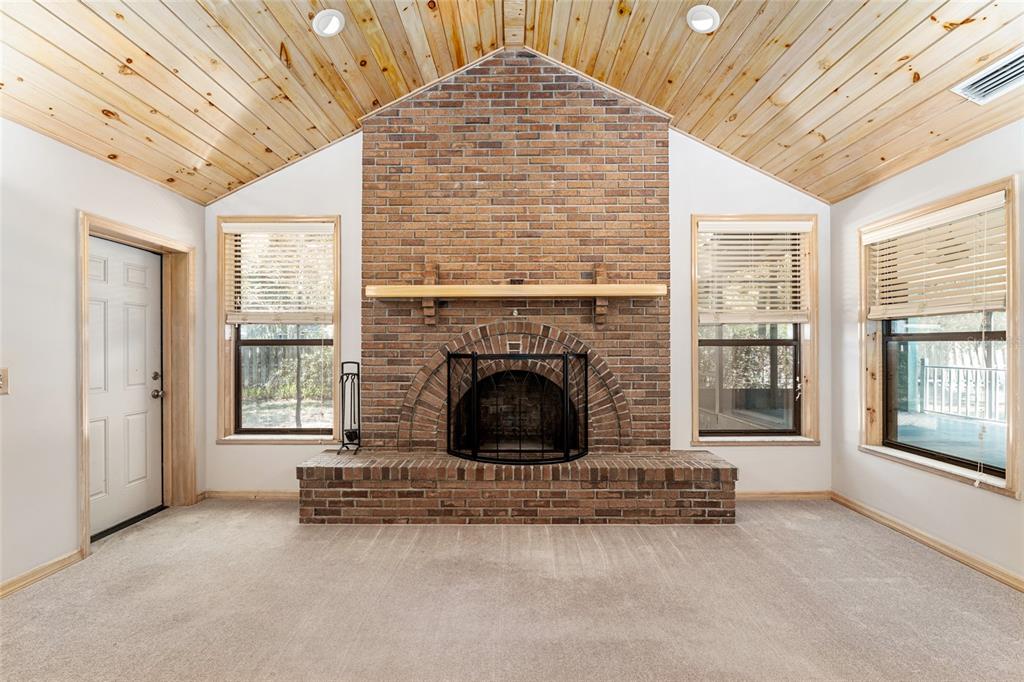 2023 Southwest 76 Terrace Gainesville, FL 32607 - Photo 14 of 95 a view of an empty room with a fireplace and a window