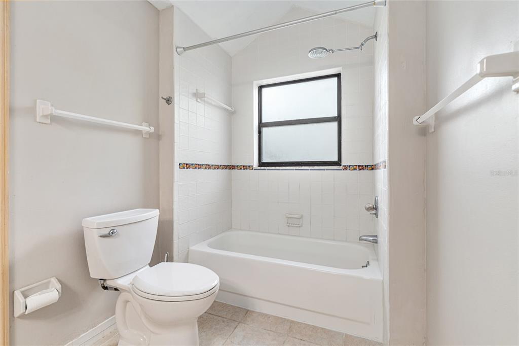 2023 Southwest 76 Terrace Gainesville, FL 32607 - Photo 27 of 95 a white toilet sitting next to a bath tub shower
