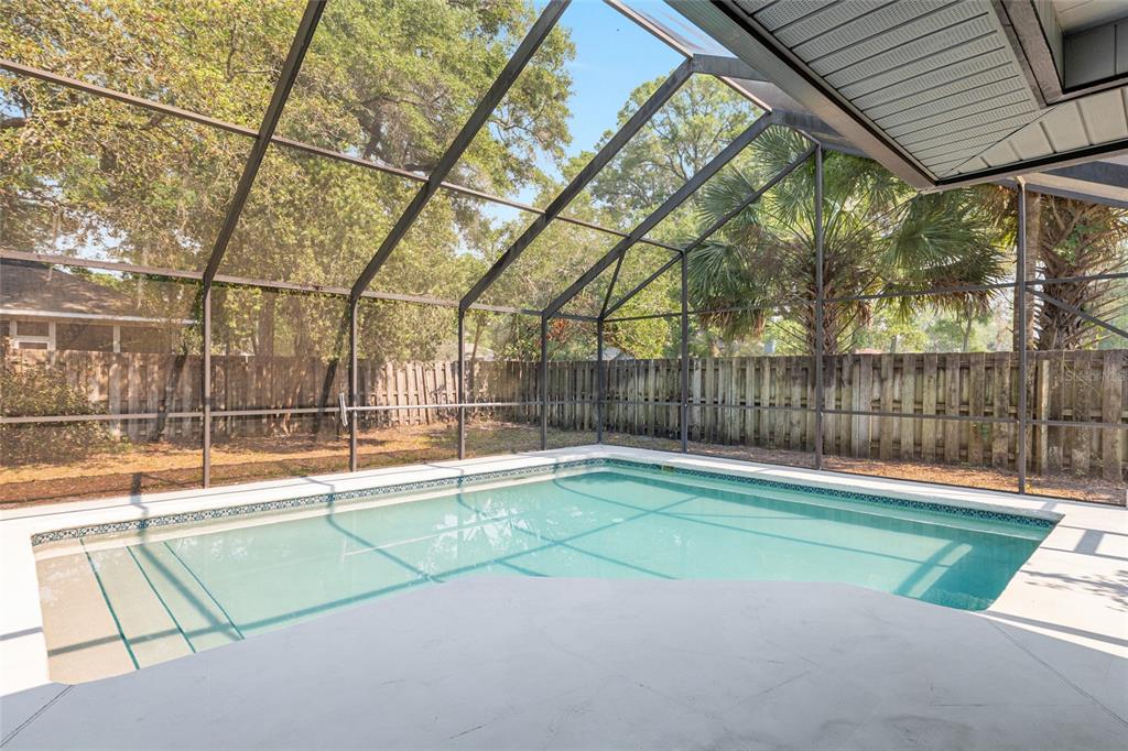 2023 Southwest 76 Terrace Gainesville, FL 32607 - Photo 65 of 95 a view of a tennis court with a small yard